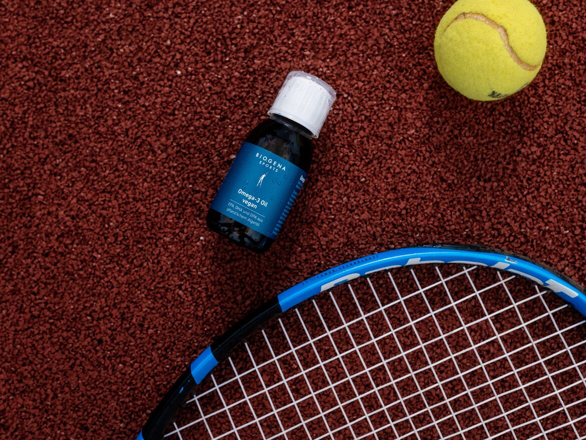 BIOGENA SPORTS - Vegan Omega-3 Oil stands on the floor next to a tennis racket and tennis ball.