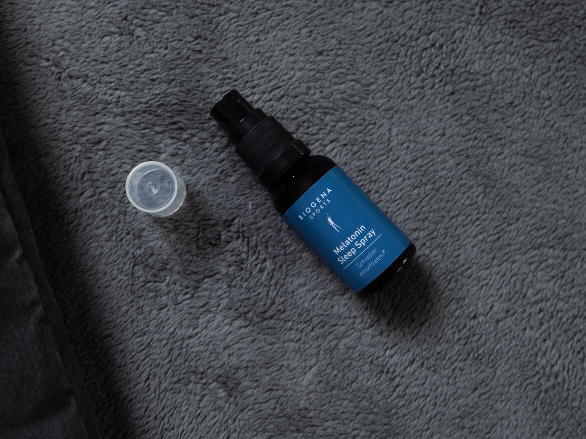 Melatonin Spray with a cap is lying on a blanket